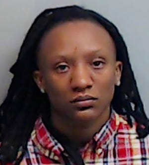 In this Nov. 2019 photo released by the Fulton County Jail, Kennesaw State basketball player Kamiyah Street poses for a booking photo, in Atlanta. Street is one of five people indicted in the July killing of a man found dead in an Atlanta parking deck. A Fulton County Sheriff's Office spokeswoman said Street turned herself in Thursday, Nov. 21, 2019. She remained in the county jail Monday without bond. (Fulton County Jail via AP)