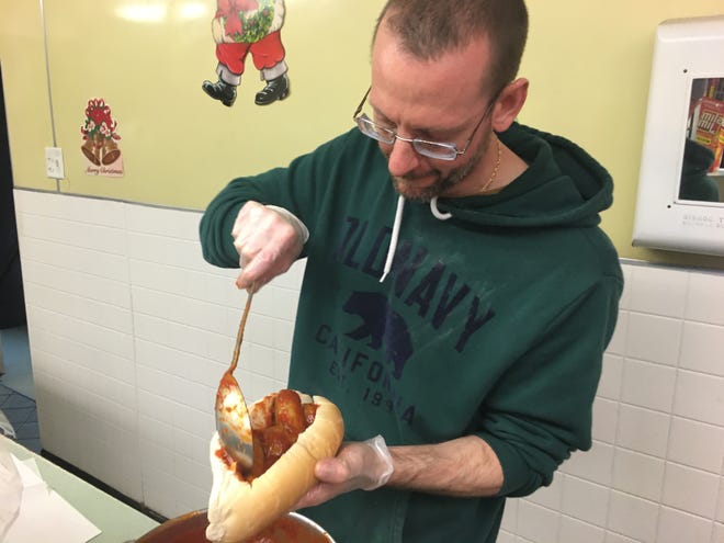 Anthony Heft, manager at D'Elia's Bakery & Grinder Shop in Norwich, makes a meatball and sausage grinder. [MATT GRAHN/NORWICHBULLETIN.COM]