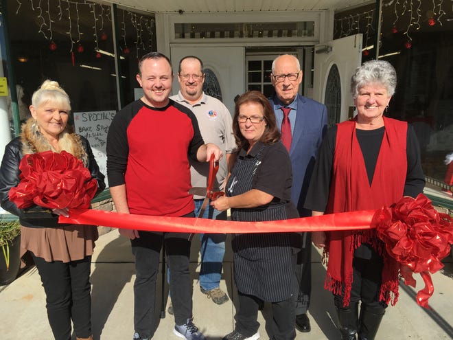 Shown above, at the grand opening of Blossom Cafe and Bakery in downtown Bessemer City, are, from left, Pat Hall, Jonathan Fioritto, Robert Grisdale, Nikki Grisdale, Ray Cunningham, and Vicki Green. [BILL POTEAT/THE GAZETTE]
