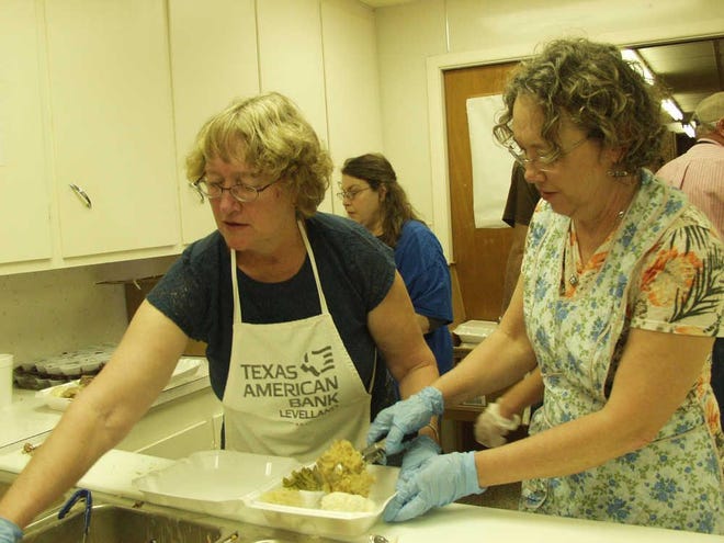 Volunteers prepare to-go plates at St. Philip Neri Catholic Church’s 70th annual Thanksgiving Festival in 2015 in Pep. [A-J Media file photo]