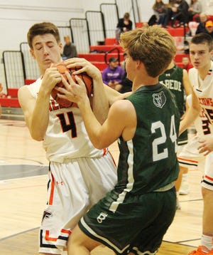 Sam Jones fights to keep possession of the ball during Tuesday's game with St. Bede.