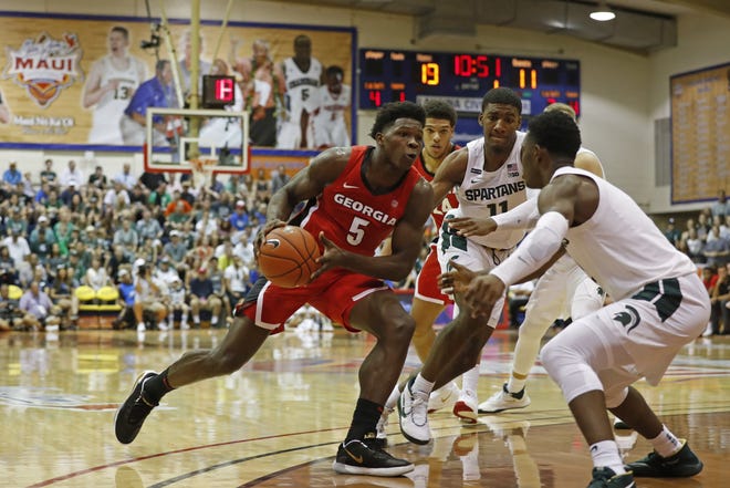 Georgia guard Anthony Edwards (5) drives into the Michigan State defense during the first half of an NCAA college basketball game Tuesday, Nov. 26, 2019, in Lahaina, Hawaii. (AP Photo/Marco Garcia)