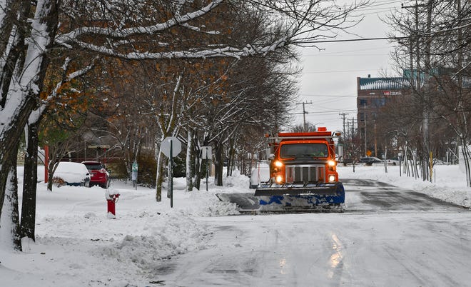 A snowplow removes about four inches of snow from a city street Wednesday, Nov. 27, 2019, in St. Cloud, Minn. According to the National Weather Service, St. Cloud received four inches of snow overnight. (Dave Schwarz/The St. Cloud Times via AP)