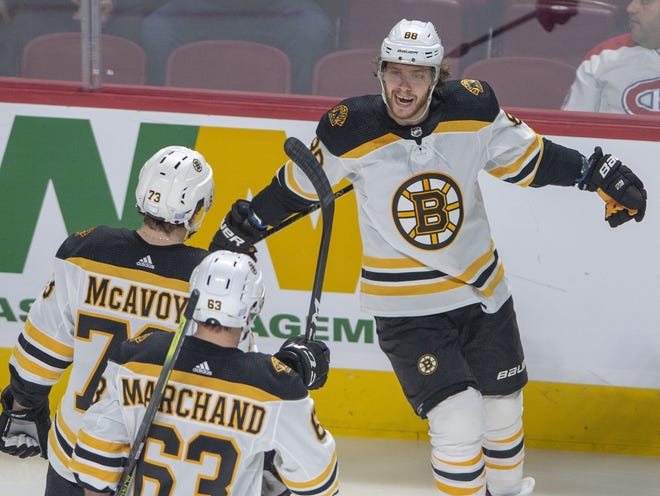 Bruins right winger David Pastrnak (right) celebrates with teammates after scoring his second goal against the rival Canadiens during Boston's 8-1 win in Montreal. Pastrnak recorded his second hat-trick of the season. [Ryan Remiorz/The Canadian Press via AP]