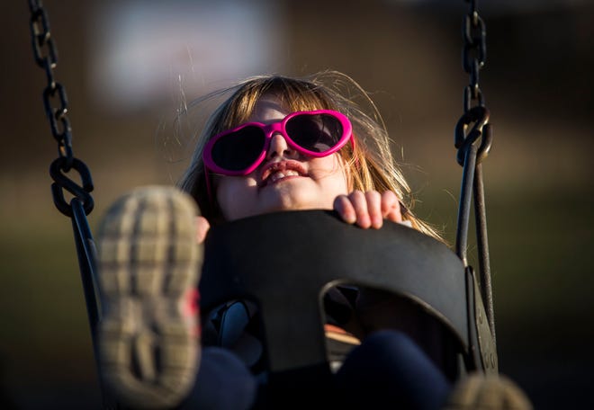 Three-year old Tessie, of Stillwater, takes advantage of the warm temperatures and sunlight Tuesday as she swings at Memory Park in Newton. Weather conditions are expected to be not nearly as pleasant through the weekend. [Photo by Daniel Freel/New Jersey Herald (NJH)]