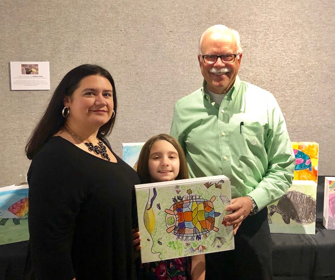 Paul Brent, at right, poses in March 2019 with one of the students who entered the annual Kids Art Contest he sponsors. [CONTRIBUTED PHOTO]