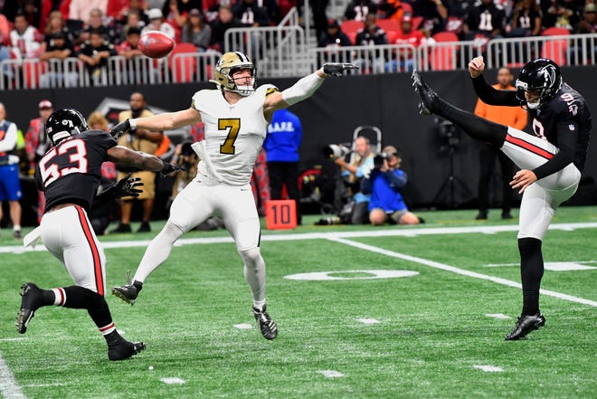New Orleans Saints quarterback Taysom Hill (7) blocks a punt by Atlanta Falcons punter Ryan Allen (9) during the first half of an NFL football game, Thursday, Nov. 28, 2019, in Atlanta. (AP Photo/John Amis)