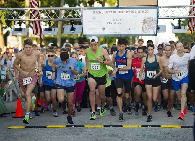 About 1,400 competitors participate Thursday in the Town of Palm Beach United Way Turkey Trot 5K at Bradley Park. The winner was Mackenzie Mettille, 22, center, green shirt. [Meghan MCCARTHY/palmbeachdailynews.com]