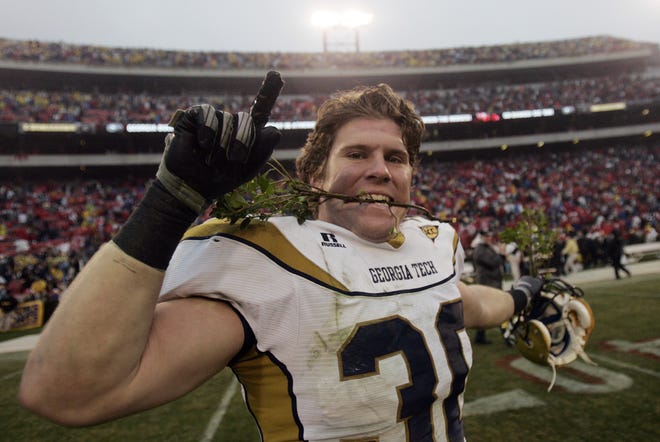 Georgia Tech linebacker James Liipfert holds a piece of the famed Sanford Stadium Hedge in his teeth as he celebrates Tech's 45-42 win over Georgia in 2008. (AP Photo/John Bazemore)