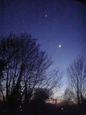 Planets and the moon often make interesting arrangements at dusk or dawn. In this photo from March 25, 2012, the crescent moon was to the right of Jupiter, with Venus (much brighter), higher in the western sky. [CDC/Wikimedia Commons/Public Domain]