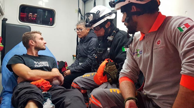 Survivor Aidan Jacobson sits inside an ambulance Wednesday after he was rescued after falling from the El Potrero Chico peak in Hidalgo, Mexico. Jacobson was climbing with California free solo climber Brad Gobright who died in the fall, civil defense officials in northern Mexico reported Thursday. [THE ASSOCIATED PRESS]