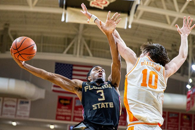 Florida State guard Trent Forrest (3) moves the arm of Tennessee forward John Fulkerson (10) to shoot in the second half at the Emerald Coast Classic in Niceville on Friday. [MARK WALLHEISER/THE ASSOCIATED PRESS]