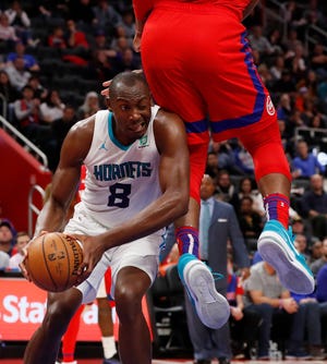Charlotte Hornets center Bismack Biyombo (8) is fouled by Detroit Pistons center Andre Drummond during the second half Friday in Detroit. {CARLOS OSORIO/THE ASSOCIATED PRESS]
