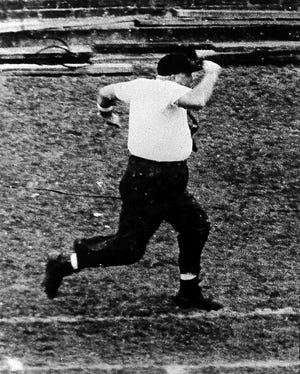 Ohio State coach Woody Hayes sprints down the sideline to protest an official’s call during the 1963 game against Michigan. [The Detroit News]