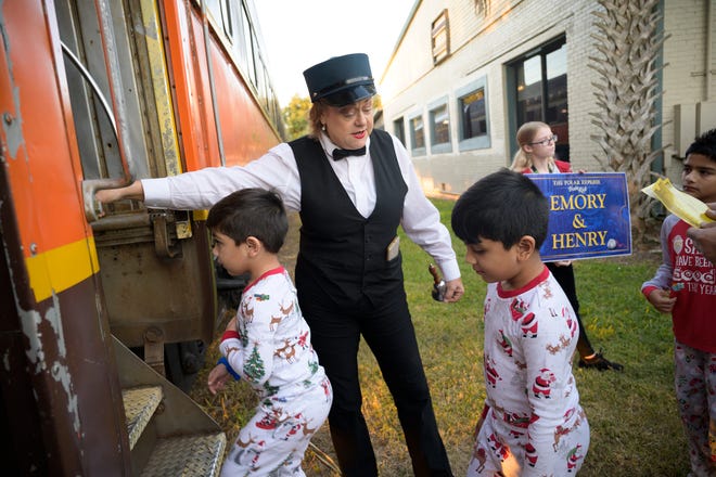 Kids board the train at The Polar Express in Eustis on Wednesday. The popular attraction is running rides through Dec. 30 this year. [Cindy Sharp/Correspondent]
