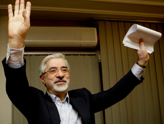 Iranian reformist presidential candidate Mir Hossein Mousavi waves to the media during a June 2009 late night news conference after polls closed in Tehran. A website long associated with detained opposition leader Mousavi has quoted him as comparing a crackdown on protesters under Iran’s supreme leader to another carried out under the country’s ousted shah. The comments published Saturday, represent some of the harshest yet attributed to Mousavi, a 77-year-old politician whose disputed election loss in 2009 led to widespread protests before being put down by security forces. [KAMRAN JEBRELLI/THE ASSOCIATED PRESS (FILE)]