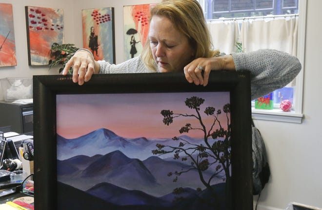 Jan Sikes, executive director of Arts n' Autism, displays some artwork for "An Evening of Arts n' Autism" in 2017. This year's event will be held from 6 to 8 p.m. Thursday at the Harrison Galleries, 2315 University Blvd. in downtown Tuscaloosa. [File Staff Photo/Gary Cosby Jr.]