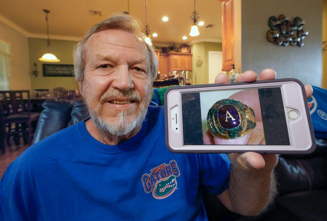 Kenneth Board holds a phone with a picture of his recovered Auburndale High School class ring at his home in Winter Haven. Board lost the ring 50 years ago at Cocoa Beach. [PIERRE DUCHARME/THE LEDGER]