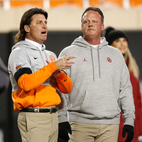 OSU coach Mike Gundy, left, talks with his brother