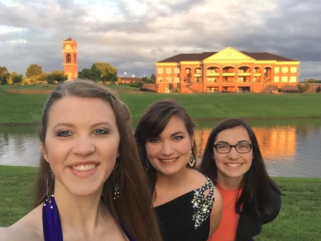 Friends (from left) Taylor Hildebrand, Leslie Watts and Tori Collie stop for a selfie at Gardner-Webb University in Boiling Springs, with Tucker Student Center and the clock tower in the background. [Special to The Star]