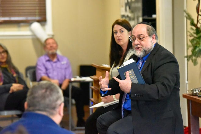 Tiffany Dahlman, pastor of Courtyard Church, and Rabbi Dov Goldberg of Beth Israel Congregation, speak Sunday at Courtyard Church in Fayetteville. [Ed Clemente for The Fayetteville Observer]