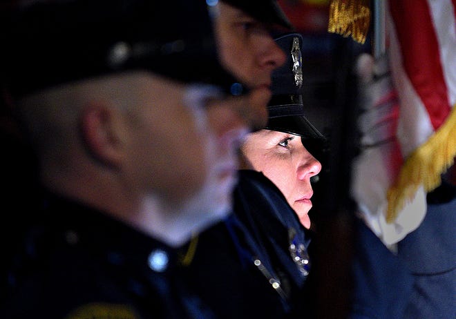 File - Jennifer Doyle, with the Abington Police Department, joins other law enforcement officers for the 20th annual Project Blue Light ceremony in Horsham last year. The Featerville Business Association its holding its annual Project Blue Light Holiday Tree Lighting on Wednesday [KIM WEIMER / PHOTOJOURNALIST]