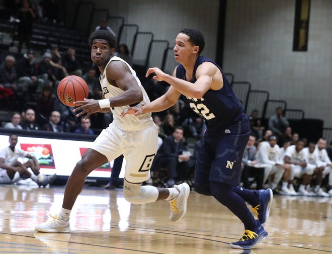 Bryant's Adam Grant drives past Navy's Cam Davis on Monday night. Grant scored 12 points in the victory. [Bryant Athletics / Dave Silverman]