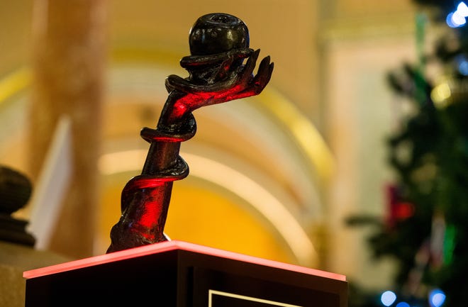 The sculpture "Snaketivity" is on display in the Illinois Statehouse rotunda Monday, Dec. 2, 2019. The piece, depicting the forearm of Eve from the Old Testament Book of Genesis, with a snake coiled around it, and holding an apple in her hand was placed by the Chicago chapter of The Satanic Temple. [Ted Schurter/The State Journal-Register]