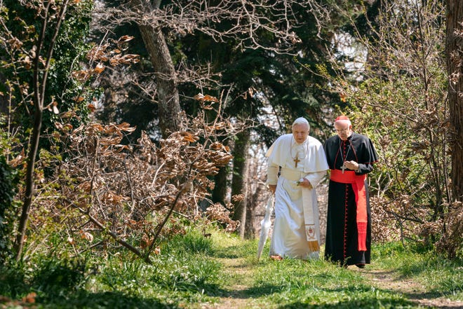 Pope Benedict (Anthony Hopkins) and Cardinal Bergoglio (Jonathan Pryce) take a stroll at the pope’s country getaway. [Peter Mountain]