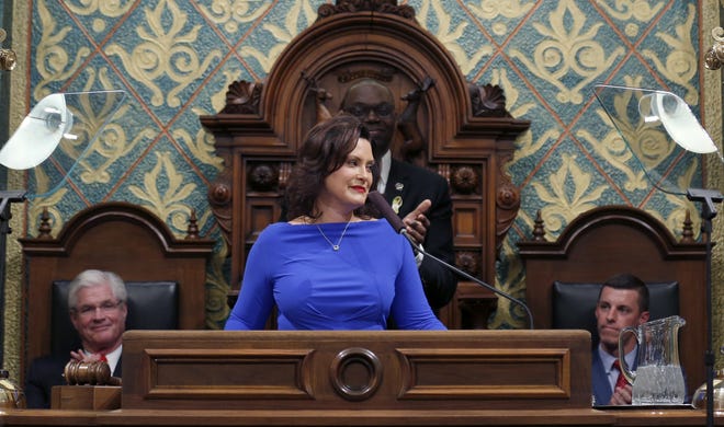 In this Feb. 12, 2019 file photo, Michigan Gov. Gretchen Whitmer delivers her State of the State address to a joint session of the House and Senate as Senate Majority Leader Mike Shirkey, House Speaker Lee Chatfield, right, and Lt. Gov. Garlin Gilchrist, rear, react, at the state Capitol in Lansing, Mich. A budget impasse in Michigan is starting to take a toll on government programs and services. Nearly two months ago, Democratic Gov. Whitmer vetoed an unprecedented $947 million in funding to restart broken-down budget talks. She and the Republican-led Legislature want to reverse some or many of her vetoes. But they remain at odds over RepublicansþÄô push to curtail her powers after the first-year governor shifted funding within state departments. (AP Photo/Al Goldis File)