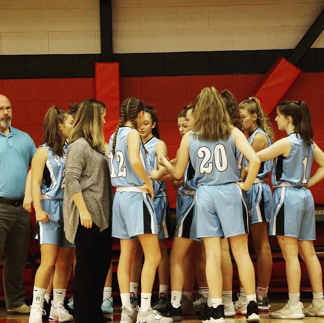 York High School girls basketball head coach Jessica Stacy, third from left, talks to her team during a timeout in a recent scrimmage. [Courtesy photo]
