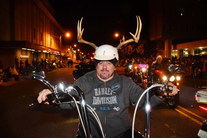 Eddie Berry of Asheboro rides his Harley Davidson Deluxe sporting antlers on his helmet during the 2017 Asheboro Christmas Parade. [Paul Church / The Courier-Tribune]
