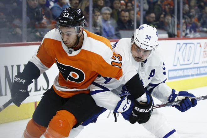 Philadelphia Flyers' Kevin Hayes (13) and Toronto Maple Leafs' Auston Matthews (34) battle for position during the third period of an NHL hockey game, Tuesday, Dec. 3, 2019, in Philadelphia. (AP Photo/Matt Slocum)