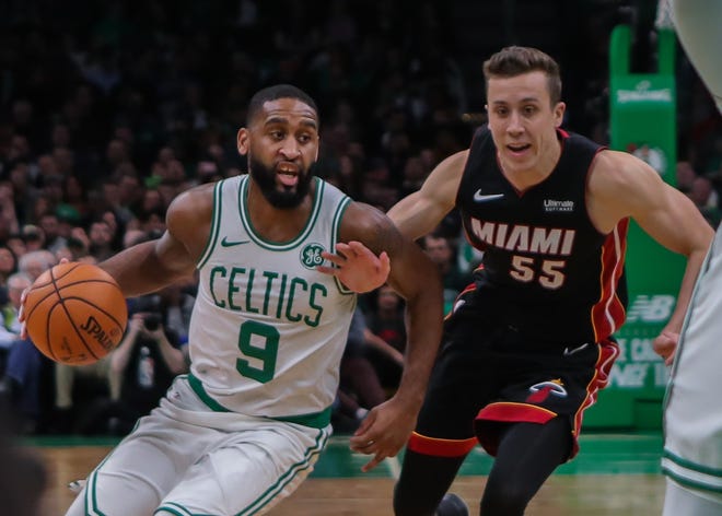 Boston Celtics' Brad Wanamaker (9) works to get around Miami Heat's Duncan Robinson during Wednesday night's game at TD Garden. [Matt Parker/Seacoastonline]
