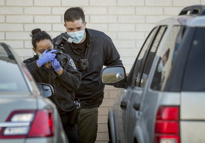 Austin police work at the scene of a fatal shooting in the parking lot of a gas station at East Riverside Drive and Montopolis Drive on Friday. Authorities say a man killed a woman before also killing himself in front of their children. [JAY JANNER/AMERICAN-STATESMAN]