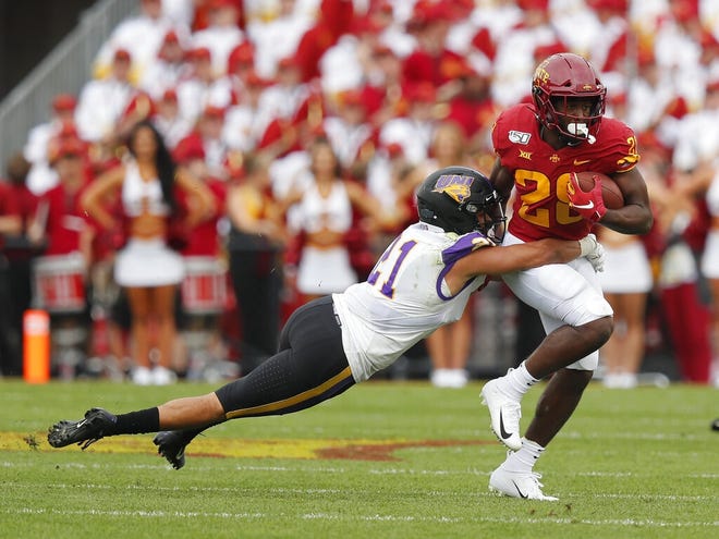 Iowa State running back Breece Hall, right, runs the ball as he is tackled by Northern Iowa defensive back Christian Jegen during the game this season in Ames. [Matthew Putney/The Associated Press]