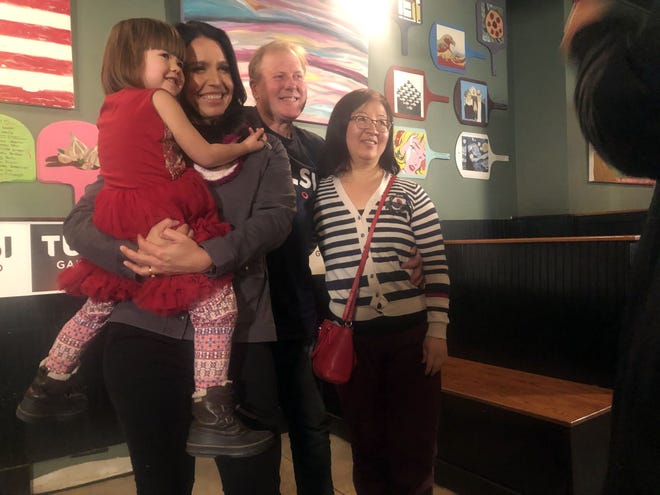 Presidential candidate Tulsi Gabbard poses for a picture with Jenny Knowles and her parents, Bill and Xiaohui Knowles, at Thursday's town hall meeting at the Community Oven in Hampton. [Max Sullivan/Seacoastonline]