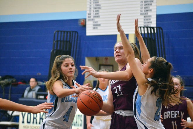 York's Clara Pavuk, left, knocks the ball away from Greely's Katie Fitzpatrick as teammate Ava Giacobba defends during Friday's Class A South girls basketball game in York, Maine. [Jay Pinsonnault/Seacoastonline]