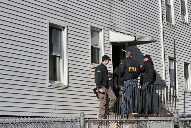 Members of multiple law enforcement agencies are seen outside the rear door of 358 N. Front St. 

[ PETER PEREIRA/THE STANDARD-TIMES/SCMG ]