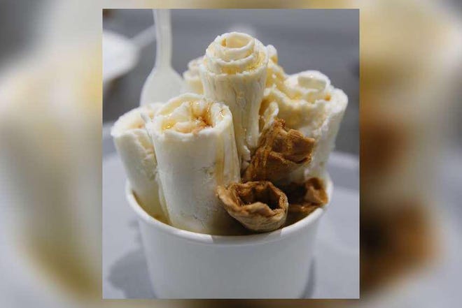 A vanilla-flavored ice cream made with banana and peanut butter mix-ins garnished with waffle cone and drizzled with honey was one flavor of rolled ice cream available at Frost Bite, seen here on Saturday, June 16, 2018.  [Staff file photo]