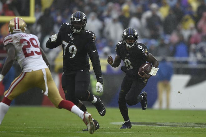 Baltimore Ravens quarterback Lamar Jackson runs the ball against the San Francisco 49ers in the first half of an NFL football game Dec. 1 in Baltimore, Md. The Buffalo Bills’ defense will try to slow Jackson and the Ravens’ offense when they meet Sunday in Orchard Park, N.Y. (AP Photo/Gail Burton)