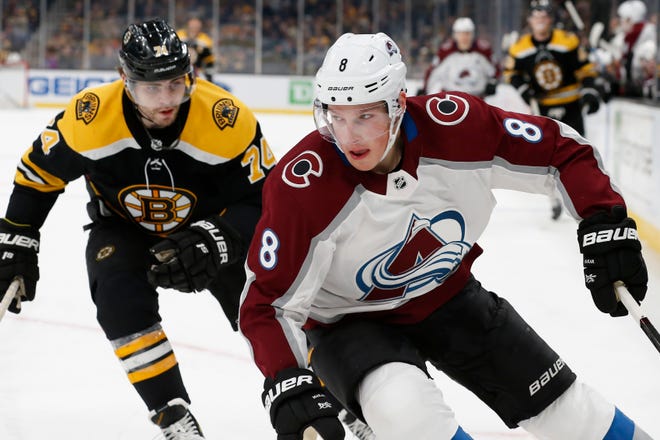 Boston Bruins' Jake DeBrusk, left, pursues Colorado Avalanche's Cale Makar during the first period in Boston on Saturday. [AP Photo/Michael Dwyer]