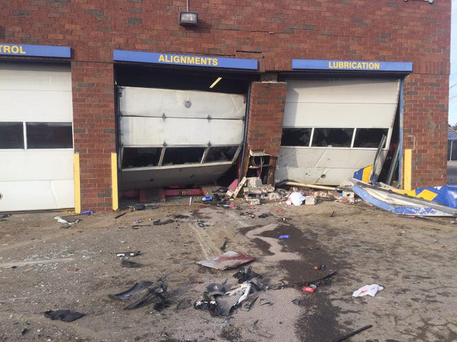 Two service bays at the NTB Tire & Service Center, 4800 Sinclair Road, are damaged after a vehicle crashed into the building early Sunday, killing three people in the vehicle. A fourth occupant was hospitalized in critical condition. [Mark Williams/Dispatch]