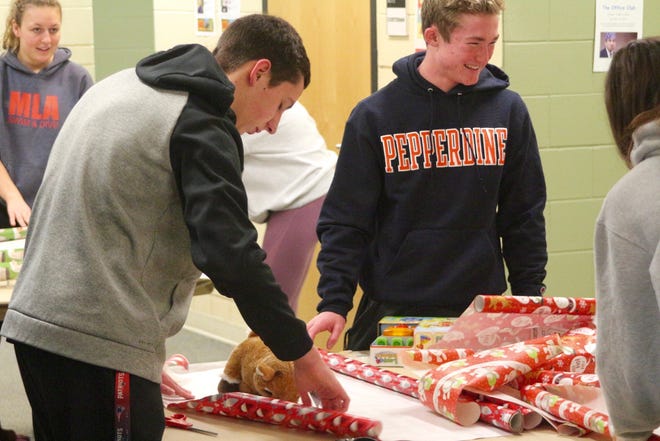 Dozens of students gathered at West Ottawa High School to help wrap presents on Saturday, Dec. 7. [Mitchell Boatman/Sentinel Staff]