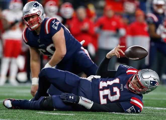 Patriots quarterback Tom Brady tosses the ball away after being sacked for a loss by Kansas City’s Chris Jones on Sunday. The Patriots lost, 23-16. [The Providence Journal / Bob Breidenbach]