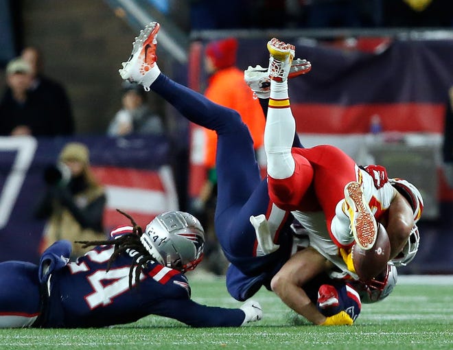 Kansas City tight end Travis Kelce loses control of the ball as he is tackled by Devin McCourty and Stephan Gilmore (24) of the Patriots after a catch in the third quarter. [The Providence Journal/Bob Breidenbach]