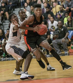 Leesburg's Jyre McCloud (23) drives to the basket against arch-rival Eustis on Thursday at the Hive in Leesburg. They remained unbeaten following a 74-62 win against the Panthers. [PAUL RYAN / CORRESPONDENT]