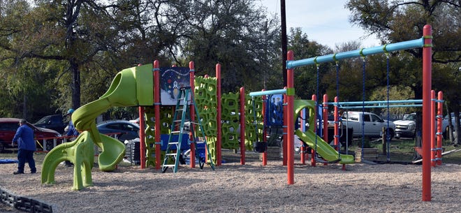 About 200 volunteers, many from the Stony Point neighborhood in Southwestern Bastrop County, gathered Nov. 16 to build a kid-designed playground in Stony Point Park. [PHOTO BY GARY BUCKWALTER - FILE]