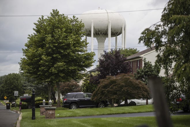 File- In this Aug. 1, 2018 photo, a water tower stands above a residential neighborhood in Horsham. In Horsham and surrounding towns in eastern Pennsylvania, and at other sites around the United States, the foams once used routinely in firefighting training at military bases contained per-and polyfluoroalkyl substances, or PFAS. EPA testing between 2013 and 2015 found significant amounts of PFAS in public water supplies in 33 U.S. states. [AP Photo/Matt Rourke]