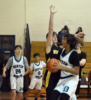 Destin's Asa Newell tries to take the ball up inside against the Ruckel Rams in middle school action. Newell scored 16 points in the 41-31 win. [TINA HARBUCK/THE LOG]